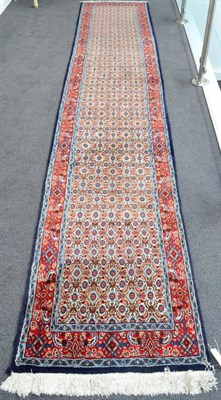 Lot 1277 - Narrow Moud Runner East Iran, circa 1970 The ivory Herati field enclosed by floral borders,...