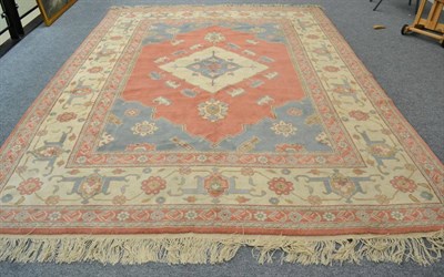 Lot 1292 - Anatolian Carpet,  late 20th century The coral pink field centred by an ivory medallion framed...