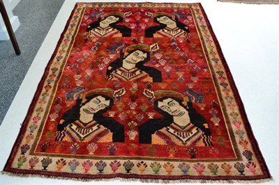 Lot 1296 - Kashgai Rug South West Iran The blood red field with five portraits of a lady enclosed by ivory...