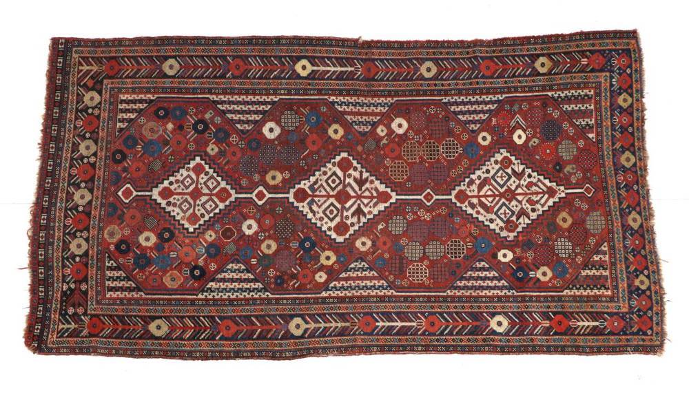 Lot 1324 - Kashgai Rug South West Iran, late 19th century The madder field of tribal devices around three...