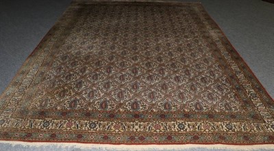 Lot 1329 - Ghom Carpet Central Iran, circa 1950 The ivory field with a lattice of botehs enclosed by...