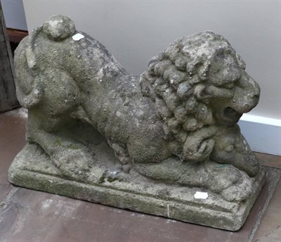 Lot 1335 - A Stone Figure of a Lion, in Medieval style, the recumbent animal over a ram's head, on a...