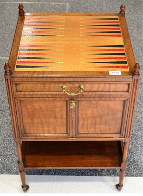 Lot 1378 - A Victorian Walnut Gaming Trolley, late 19th century, the leather top above a long frieze door with