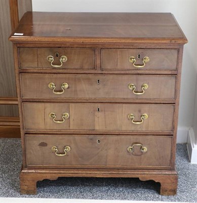 Lot 1380 - A George II Walnut Straight Front Chest, Mid 18th Century, the moulded top above two short and...