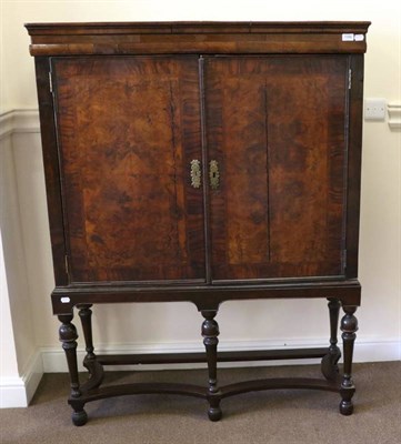 Lot 1396 - A Walnut and Featherbanded Cabinet on Stand, with two featherbanded and crossbanded cupboard...