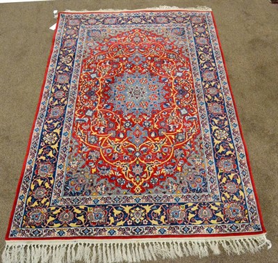 Lot 912 - A Finely Knotted Isfahan Rug Central Iran The crimson field of scrolling floral vines around an ice