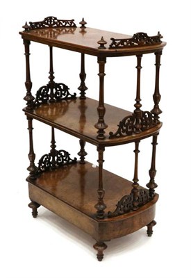 Lot 1401 - A Victorian Figured Walnut Three-Tier Whatnot, circa 1870, with fluted spindle supports and pierced