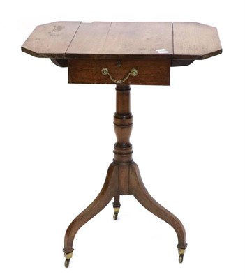 Lot 1414 - A Regency Mahogany Revolving Tripod Table, early 19th century, with angular drop leaves above a...