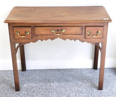 Lot 1416 - A George III Mahogany Dressing Table, late 18th century, the moulded top above three small...