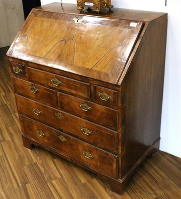 Lot 1421 - An Early 18th Century Figured Walnut and Featherbanded Bureau, the fall enclosing a fitted interior