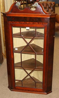 Lot 1446 - A George III Mahogany Hanging Corner Cupboard, late 18th century, the swan neck pediment above...