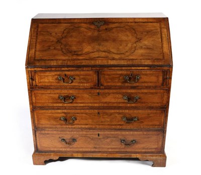 Lot 1454 - A George II Walnut and Feather-Banded Bureau, 2nd quarter 18th century, the quarter-veneered...