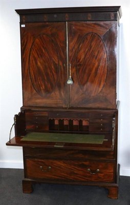 Lot 1456 - A George III Mahogany and Rosewood Crossbanded Secretaire Linen Press, early 19th century, the...