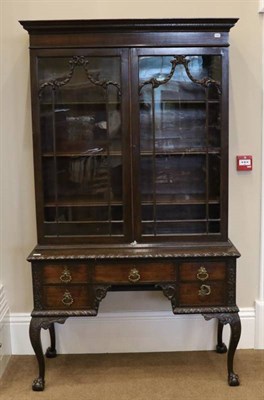Lot 1465 - A Carved Mahogany Chippendale Revival Cabinet on Stand, late 19th century, the Greek Key dentil...