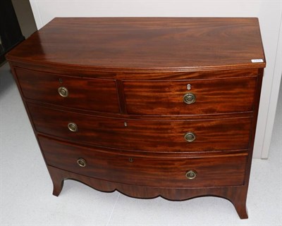 Lot 1472 - A Late George III Mahogany Bowfront Chest, early 19th century, with reeded edge above two short and