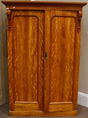 Lot 1473 - A Victorian Satin Birch Double Door Wardrobe, circa 1870, the moulded cupboard doors between carved