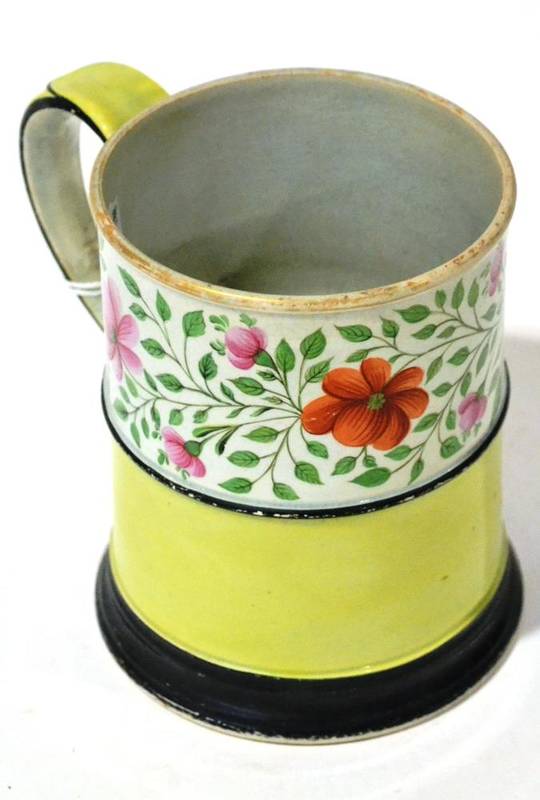 Lot 109 - A Pearlware Mug, circa 1810, of cylindrical form, painted with a band of foliage on a yellow...