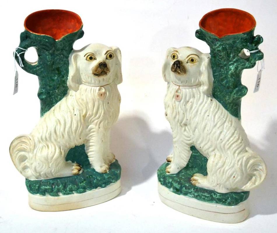 Lot 116 - A Pair of Staffordshire Pottery Spill Vases, 19th century, as spaniels seated before tree...
