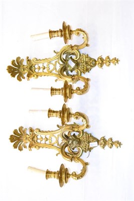 Lot 1014 - A Pair of Gilt Bronze Two-Branch Light Fittings, in Régence style with shell cresting,...