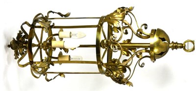 Lot 1027 - An Edwardian Brass Hall Lantern, with leaf and scroll decoration, 77cm high, fitted for electricity