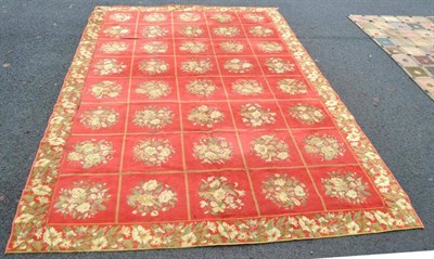 Lot 246 - Machine Made Carpet The tomato red compartmentalised field containing floral sprays enclosed by...