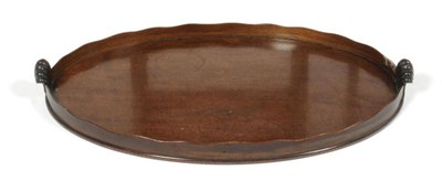 Lot 280 - A George III Mahogany Oval Tray, early 19th century, with wavy shaped gallery and shell carved...