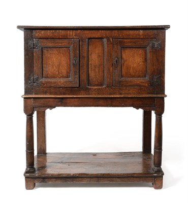 Lot 1056 - A Joined Oak Livery Cupboard, late 17th/early 18th century, with two fielded cupboard doors, raised