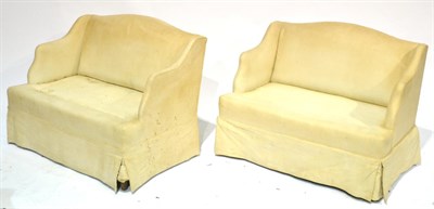 Lot 359 - A Pair of Wing Back Sofas of Small Proportions, 1st half 20th century, upholstered in cream fabric