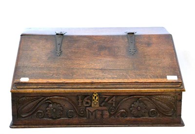 Lot 1063 - An English Oak Desk Box, carved 1674 and initialled MT, the hinged lid with metal hinges...