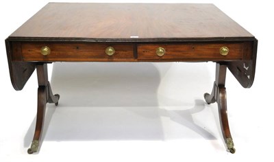 Lot 377 - A Regency Mahogany and Ebony Strung Sofa Table, early 19th century, with rounded drop leaves...