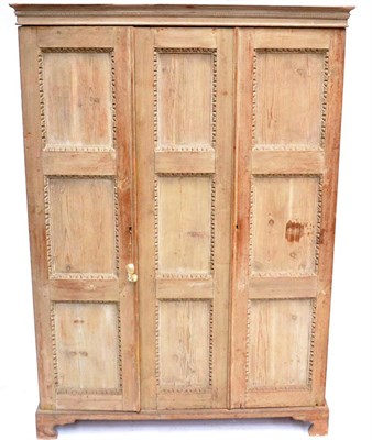 Lot 322A - A 19th Century Limed Oak Triple Door Cupboard, with egg and dart carved moulding and nine...