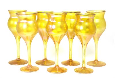 Lot 90 - John Ditchfield for Glasform; a set of seven iridescent gold goblets, each etched to base J....