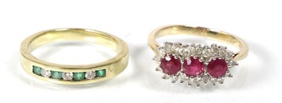 Lot 192 - A 9 carat gold ruby and diamond cluster ring, three round cut rubies within a border of round...