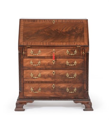 Lot 1155 - A George III Style Carved Mahogany Bureau, made by J W Varley, April 1928, the fall enclosing...