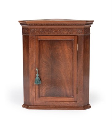 Lot 1157 - A Carved Mahogany Hanging Corner Cupboard, made by E W & T Varley & Son, Whitby, June 1951, the...