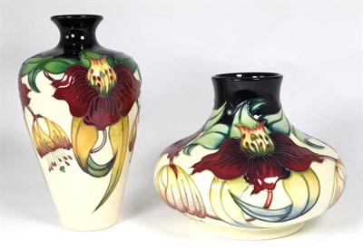 Lot 130 - Moorcroft Pottery: An Anna Lily pattern baluster vase, 24cm high; together with a squat vase in the