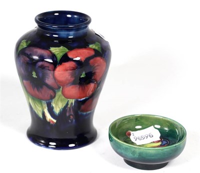 Lot 144 - A Moorcroft pottery Pansy pattern vase together with a small Moorcroft dish (2)