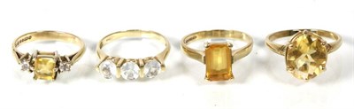 Lot 163 - A 9 carat gold pale aquamarine three stone ring, finger size O; a 9 carat gold oval cut citrine...