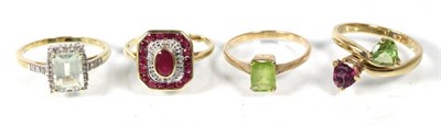 Lot 164 - A 9 carat gold ruby and diamond cluster ring, an oval cut ruby within a border of diamonds and...