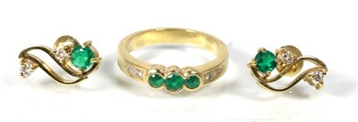 Lot 175 - A pair of emerald and diamond earrings, round cut emeralds to a scroll bar set with two round...