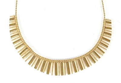 Lot 277 - A fringe necklace, the front of graduated plain and textured bar links, to a beaded chain,...