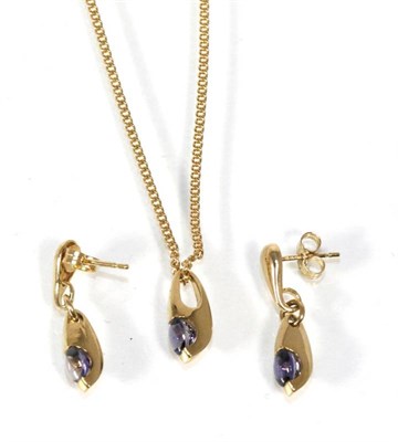 Lot 300 - A 9 carat gold iolite pendant and earring suite, a round cabochon iolite tension set to a...