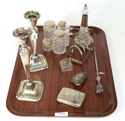 Lot 314 - Assorted silver items including four division toast rack; a cigarette case; a purse; toilet...