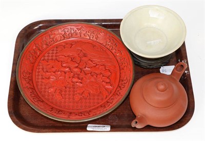 Lot 323 - A Chinese cinnabar lacquer dish carved with flowers, a Yi Xing teapot and a Sung type bowl on...