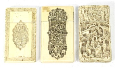 Lot 473 - A 19th century Chinese Canton carved ivory card case with slip cover; and two others (one a.f.) (3)