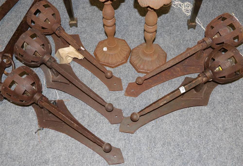 Lot 1156 - A set of five metal medieval style wall sconces converted to electricity, height 68cm