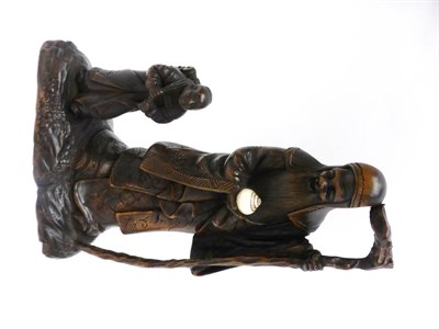 Lot 127 - A Japanese Carved Hardwood Figure Group, Meiji period, as an old man with long beard holding a...