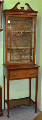 Lot 1245 - A cross banded and inlaid mahogany curio cabinet on stand fitted with a lined drawer and the...