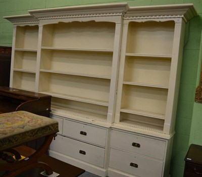 Lot 1254 - A large painted pine breakfront bookcase