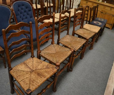 Lot 1302 - A matched set of five oak rush seated ladder back dining chairs and a set of three Regency mahogany